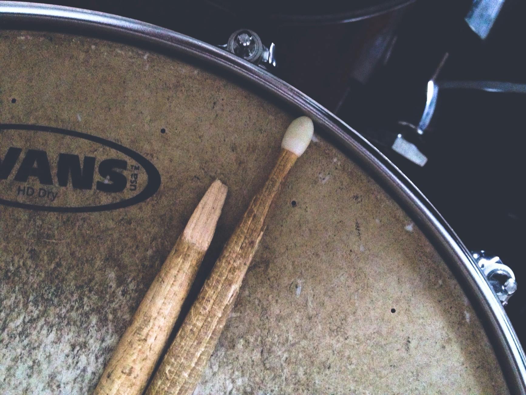 two brown drum sticks on brown snare stick